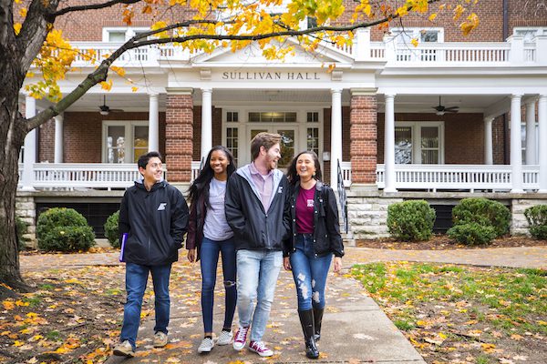 students walk together on campus in fall