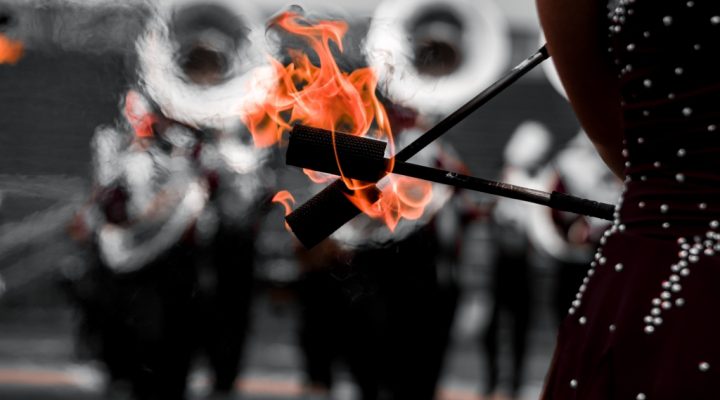 batons lit with fire during a Marching Colonels performance