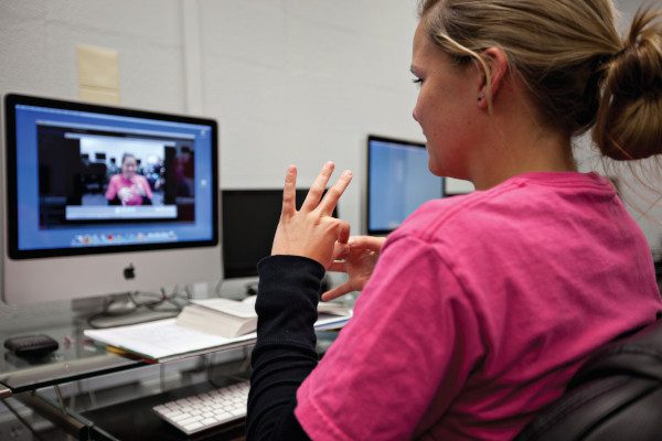 Woman using sign language on a remote video call