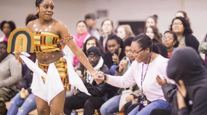 A student dances with an audience member at the 2018 Soul Food and Culture event.