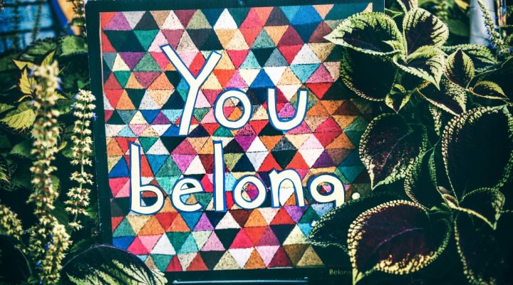 A handmade sign with the words "You belong" written upon it.