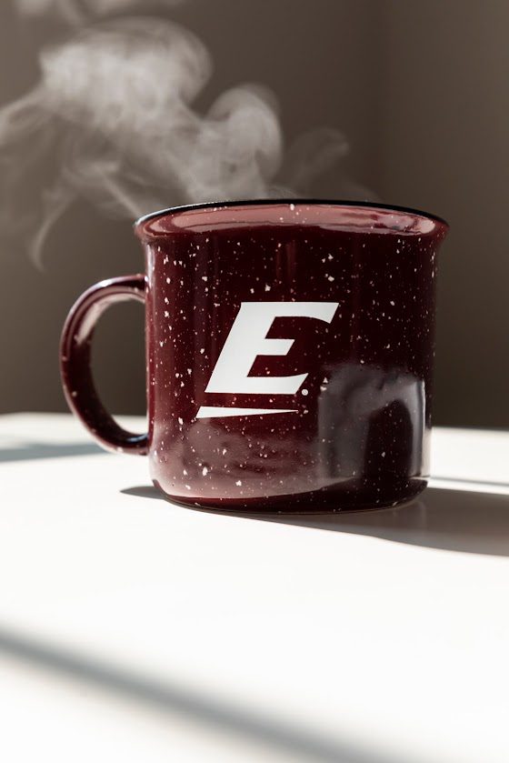 steaming hot maroon coffee mug with a big E