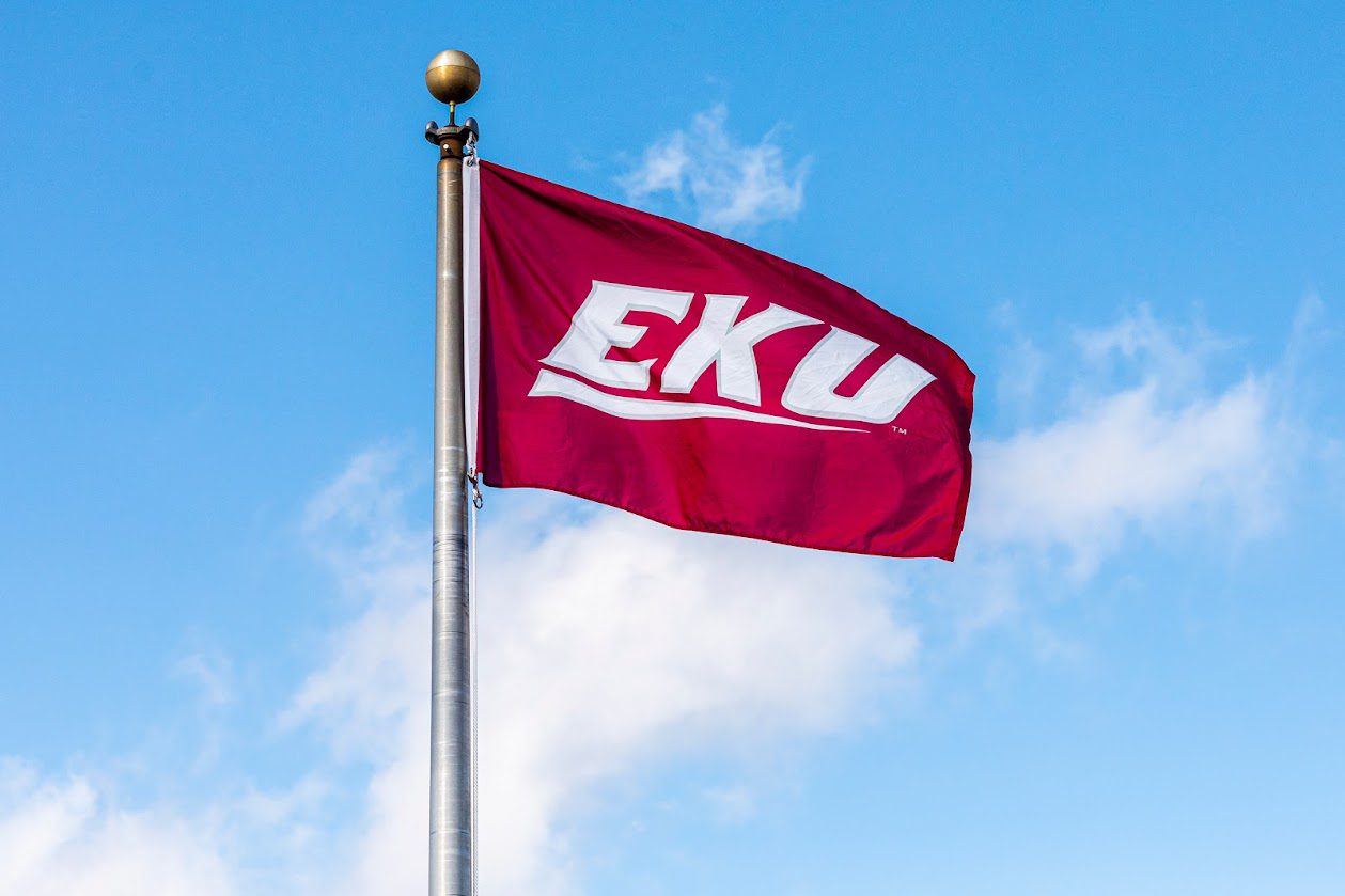 EKU flag flying against a blue sky