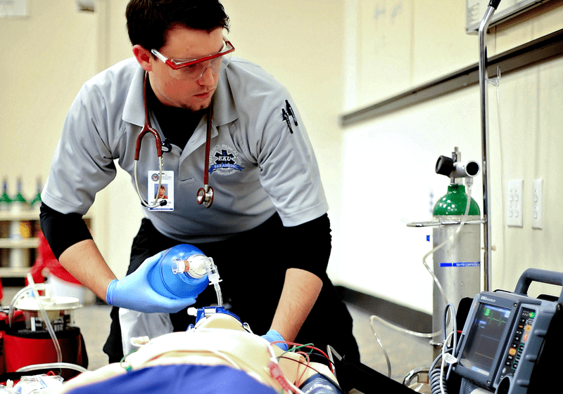 An image of an EMC worker practicing on a mannequin.