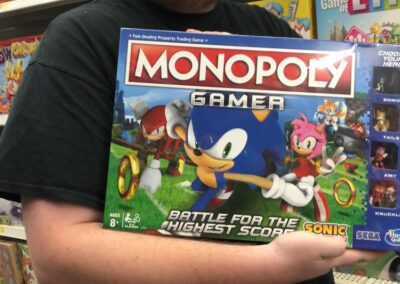 An IT Geek holding a Monopoly box