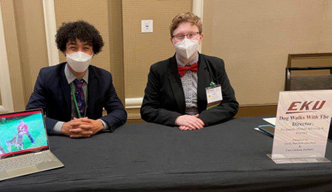 two EKU Honors students in N-95 masks sit at a conference table