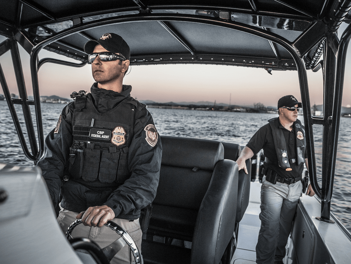 Two Homeland Security officers on boat. 