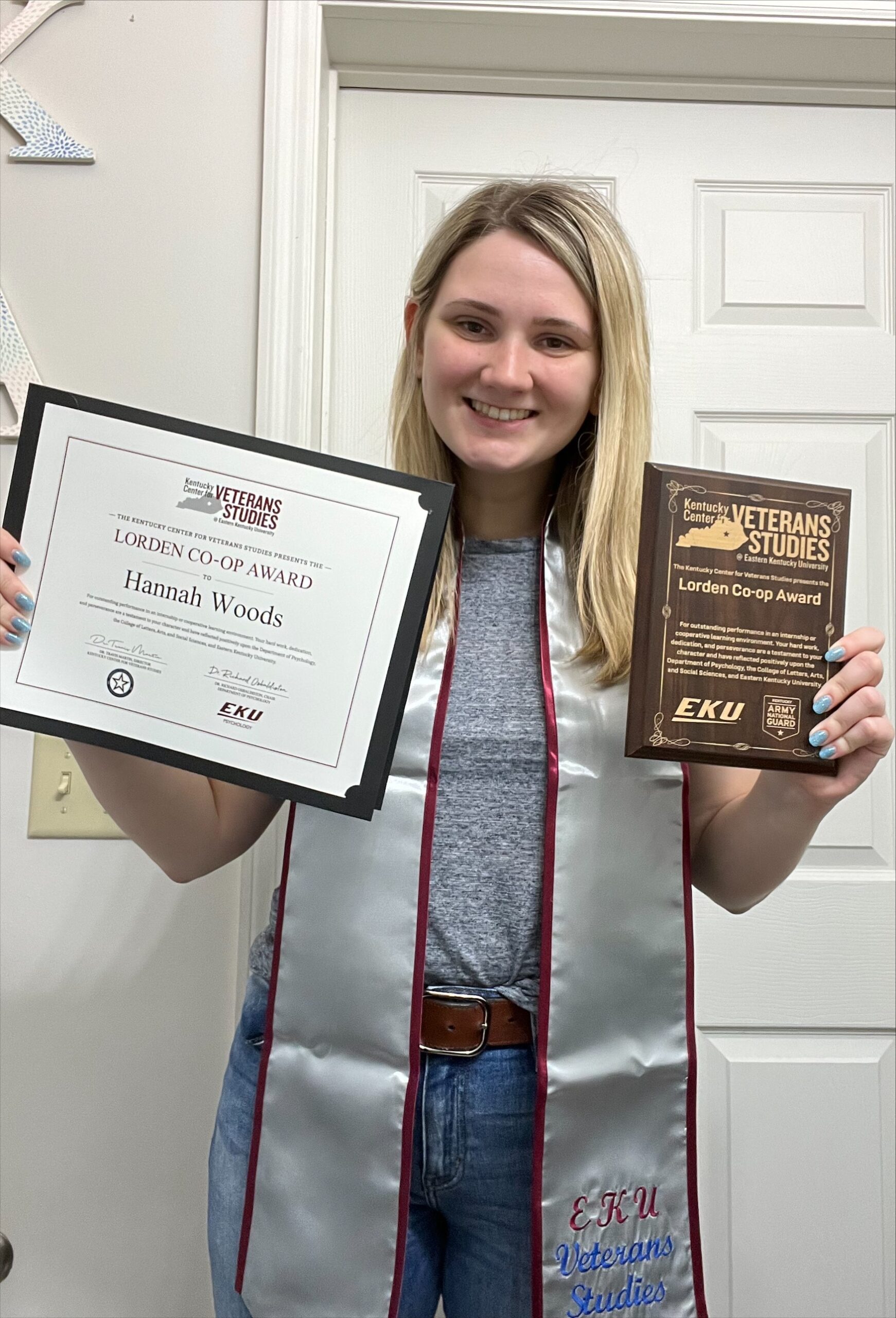 Hannah Woods poses with her veterans studies awards