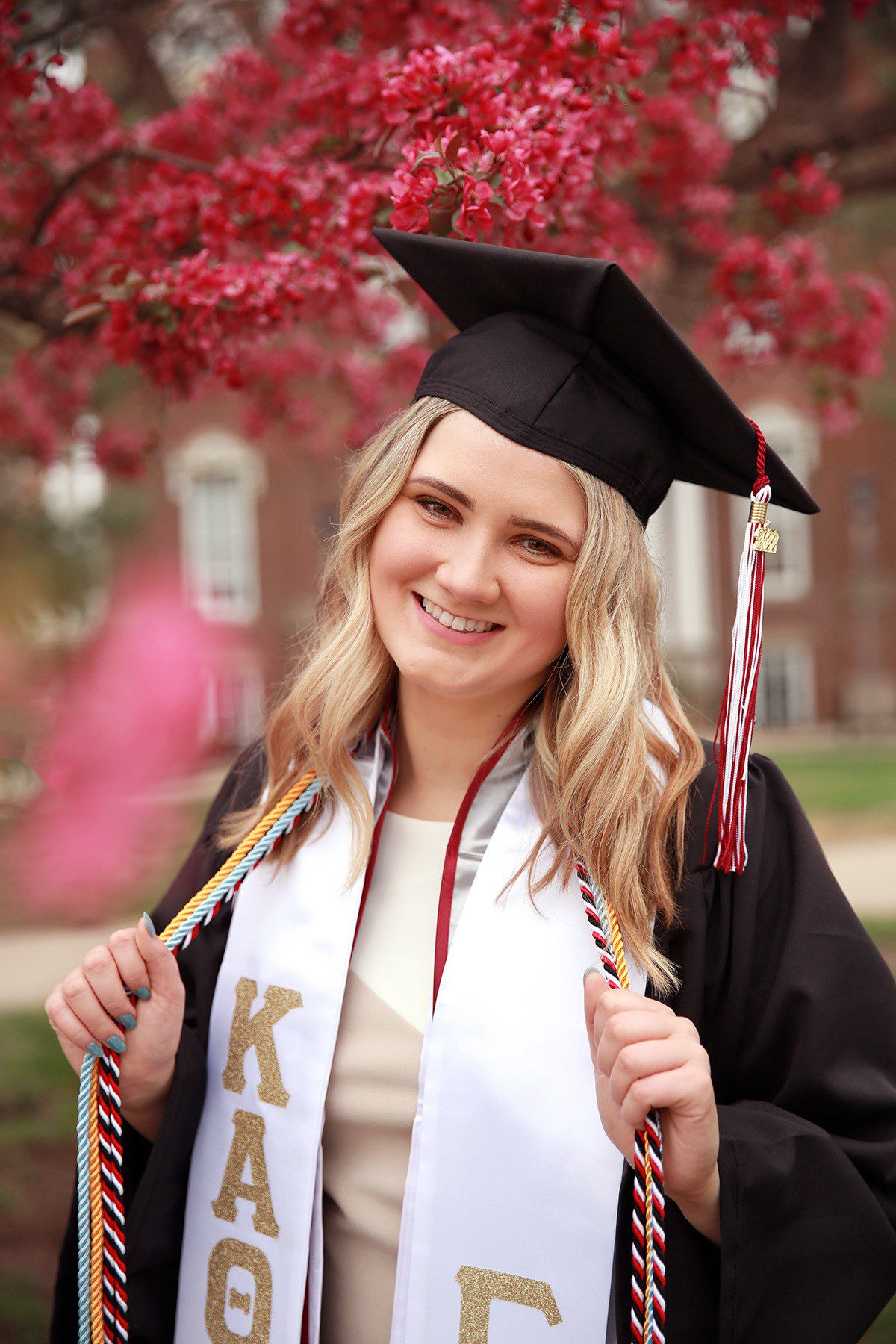 Hannah Woods poses in her cap and gown