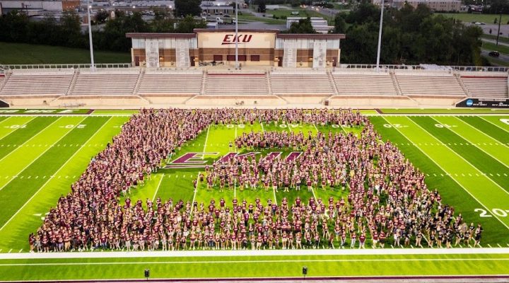Students forming an E on the football field for Big E Welcome.