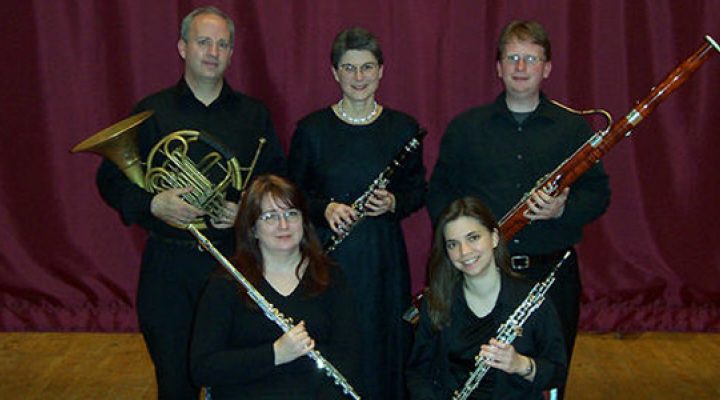 the Faculty Woodwind Quintet poses with their instruments