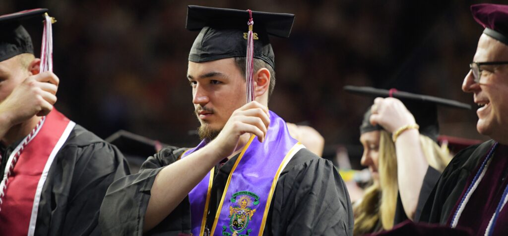 An image of students moving their tassels at one of Eastern Kentucky University's 2023 Spring commencement ceremonies.