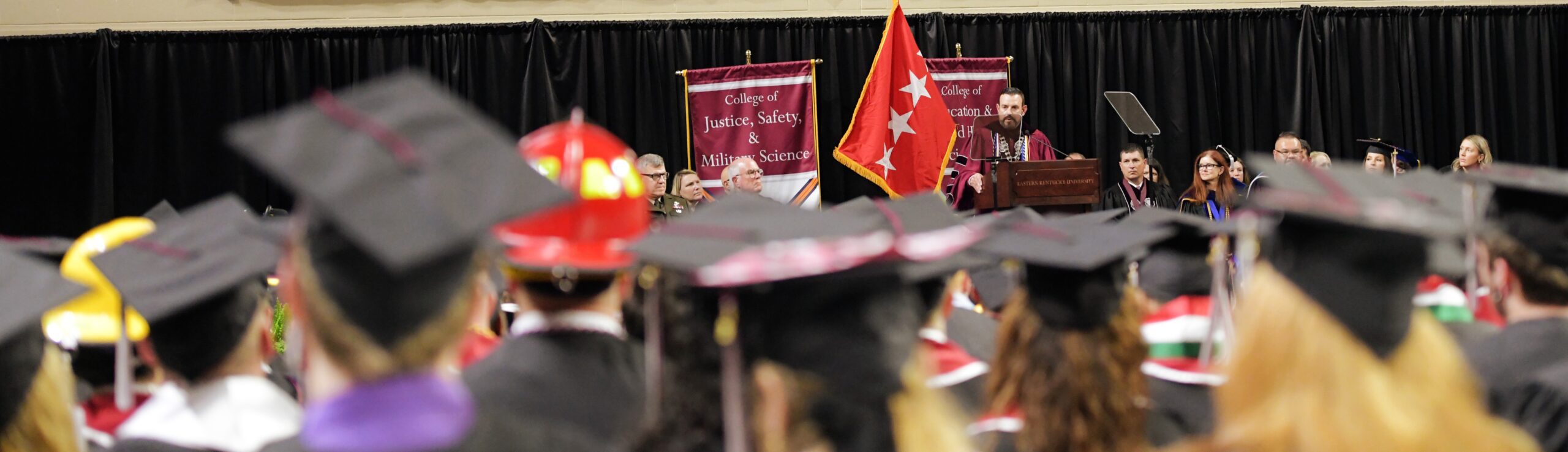An image of the 2023 Spring Commencement Ceremony at Eastern Kentucky University, with students and the EKU Banner.