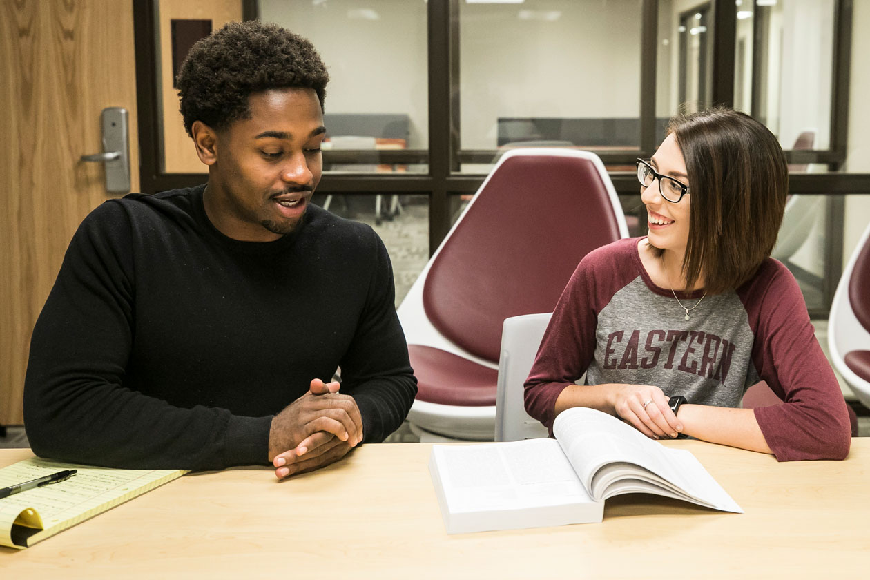 Two EKU students study together at a table