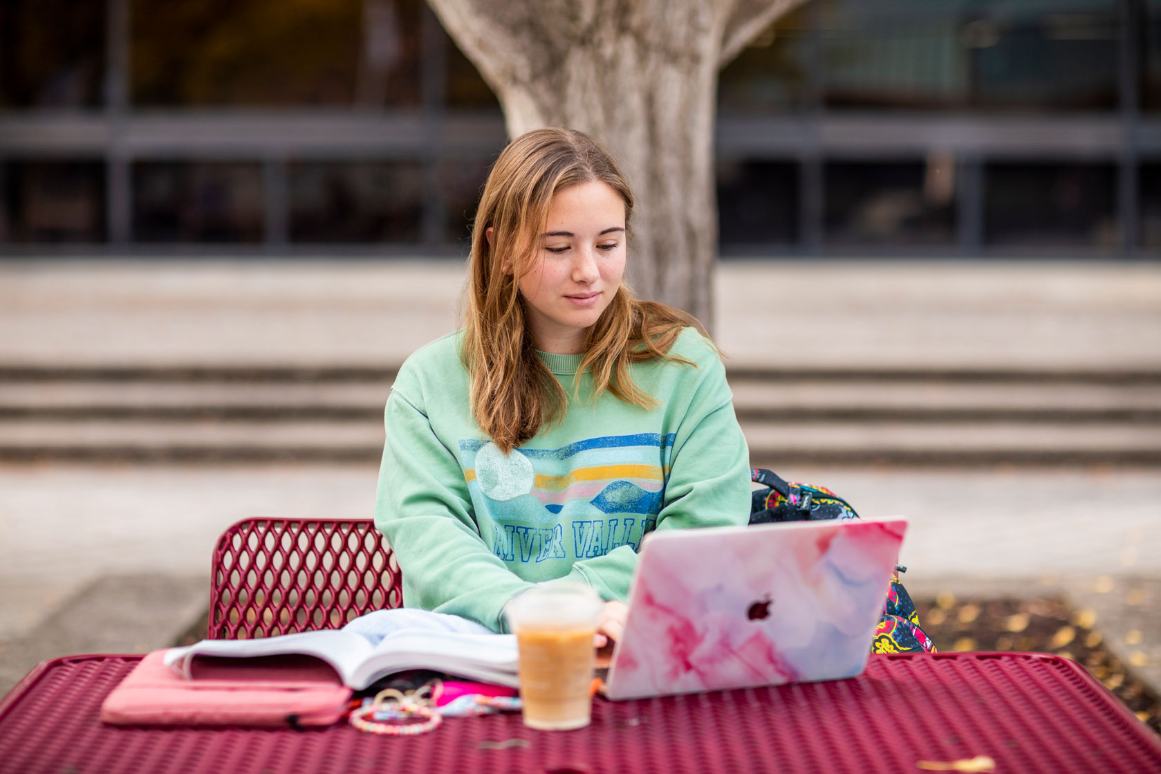a student uses a laptop outside