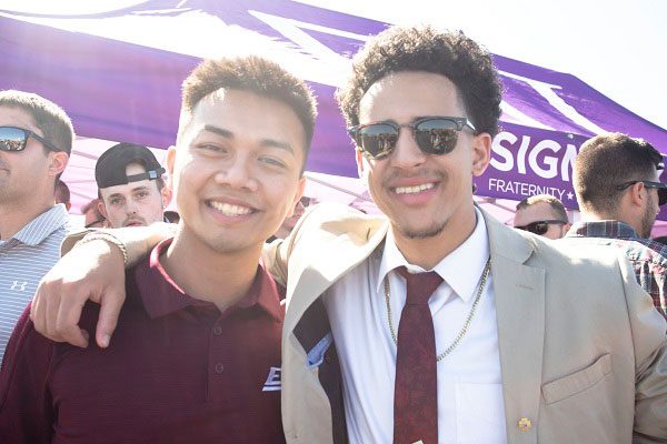 Two students pose at a tailgate