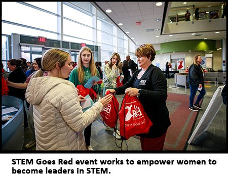 Young women recieve goodiw bags at STEM Goes Red event