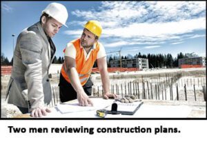 two men reviewing construction plans