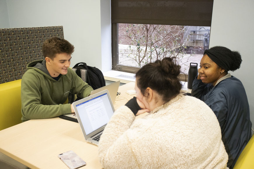 Students study together in a common area of the library 