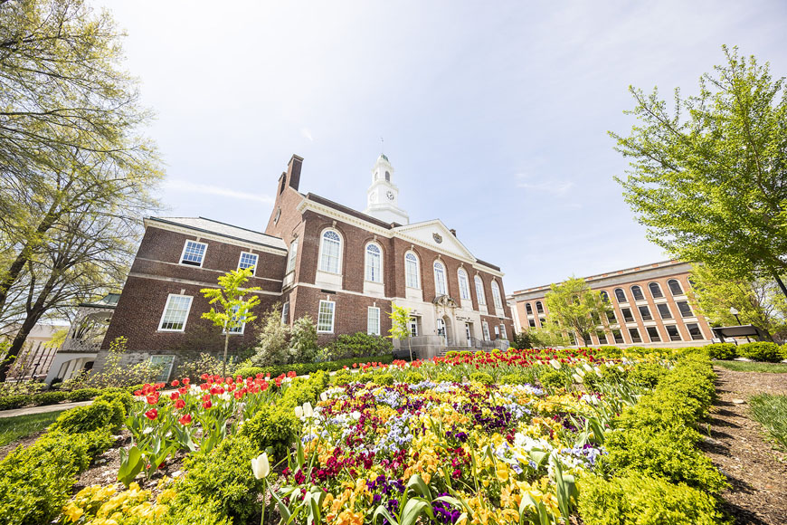 A variety of colored flowers in front of Keen Johnson during the Spring semester