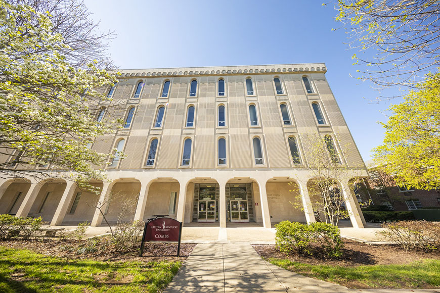 Combs building surround by greenery during Spring semester