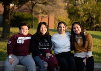 Four students pose together smiling
