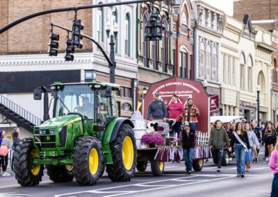 Queue of floats and tractors at Homecoming parade event