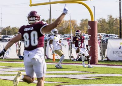 EKU football player with one finger held up during play