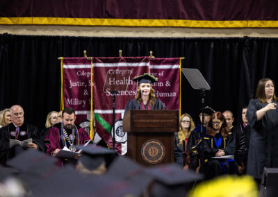 Graduating student speaking at podium during ceremony