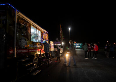 Cheesesteak food truck with line of students at night