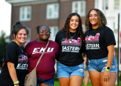 Four students wearing EKU branded shirts pose together