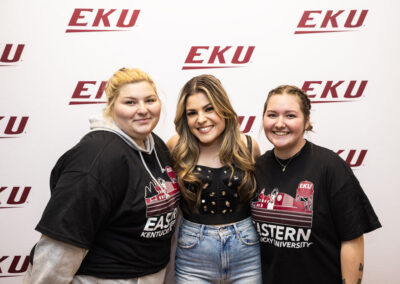 Tenille Arts with two fans in front of EKU backdrop