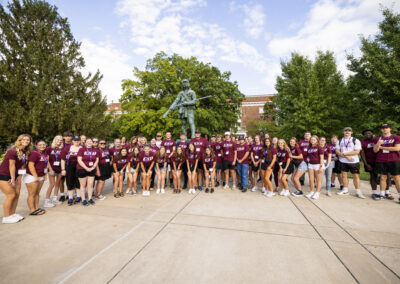 A large group of student pose for a photo in EKU shirts