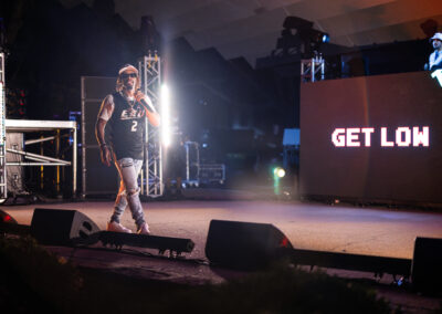 Lil Jon performs in front of a screen that says get low