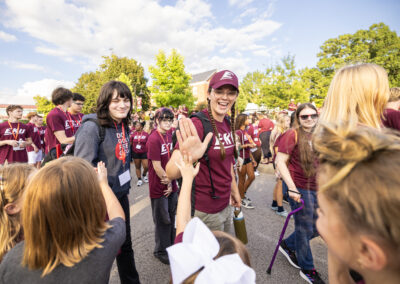 EKU students giving high-fives to small children