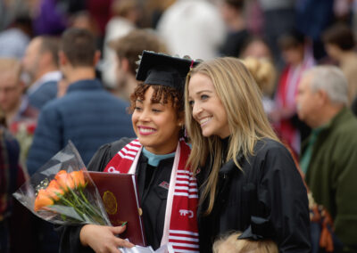 A graduate at Eastern Kentucky University's Fall 2023 Commencement ceremony taking a picture.