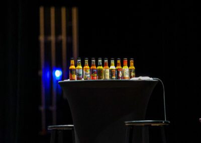 The infamous Hot Ones hot sauces lined up on stage at Eastern Kentucky Univeristy.