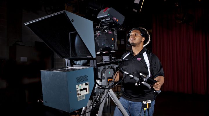 An image of an Eastern Kentucky University student working using a video camera.