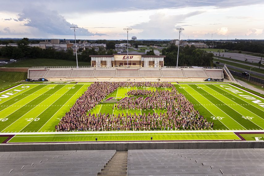 Students forming an E on EKU's football field.