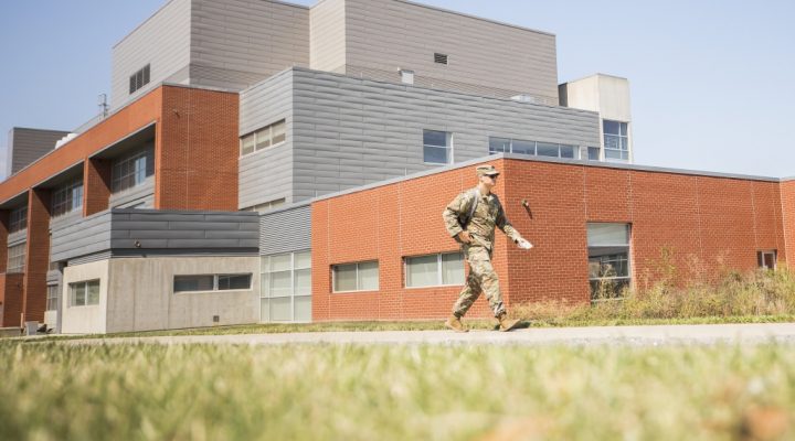 A military student walking in front of the New Science Building at Eastern Kentucky University.