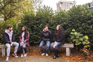 Four students sitting on benches talking - link to EKU Student Life