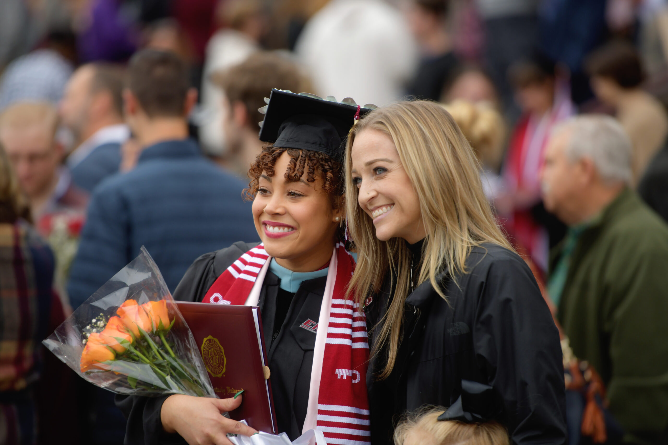 A graduate taking a picture following Eastern Kentucky University's Fall 2023 Commencement.
