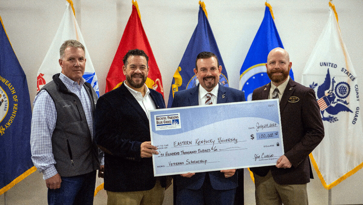 EKU President David Mcfaddin being presented a large check by Bechtel Parsons Blue Grass