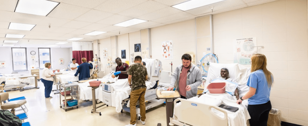 EKU nursing students learning in hospital environment with high-fidelity adult mannequins in hospital beds.