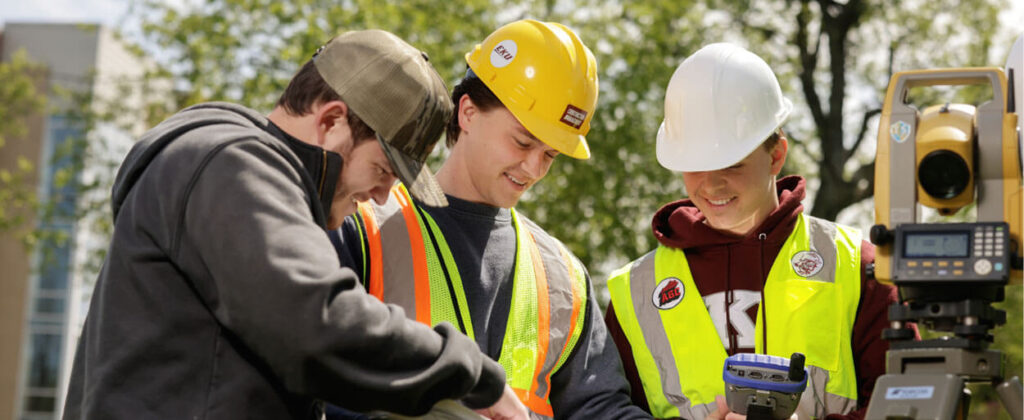 Header image group of construction management students looking at a tablet