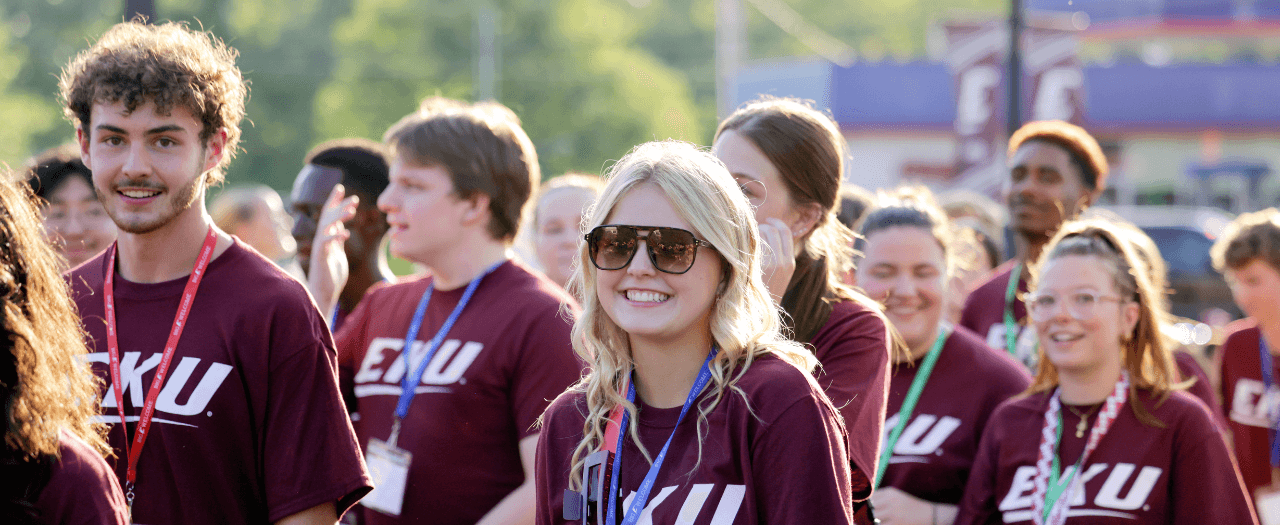 large group of smiling students all wearing maroon EKU shirts