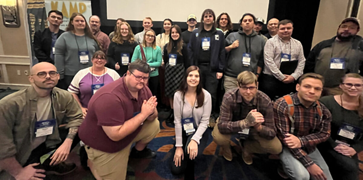 group of people at a conference posed for a photo