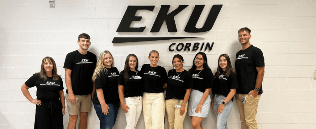 large group of people in black t-shirts stand in front of EKU Corbin sign