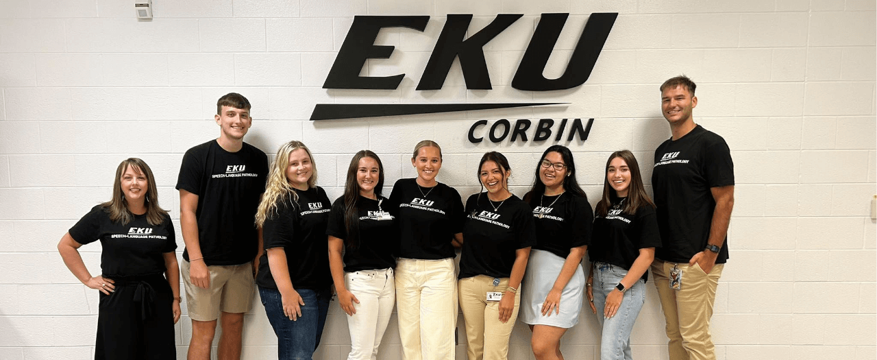large group of people in black t-shirts stand in front of EKU Corbin sign