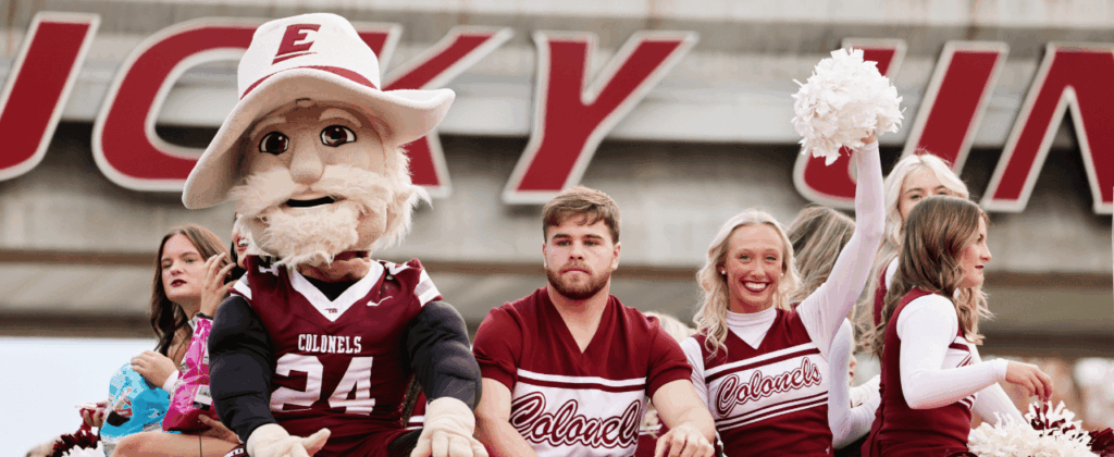 the colonel mascot along with three eku cheerleaders